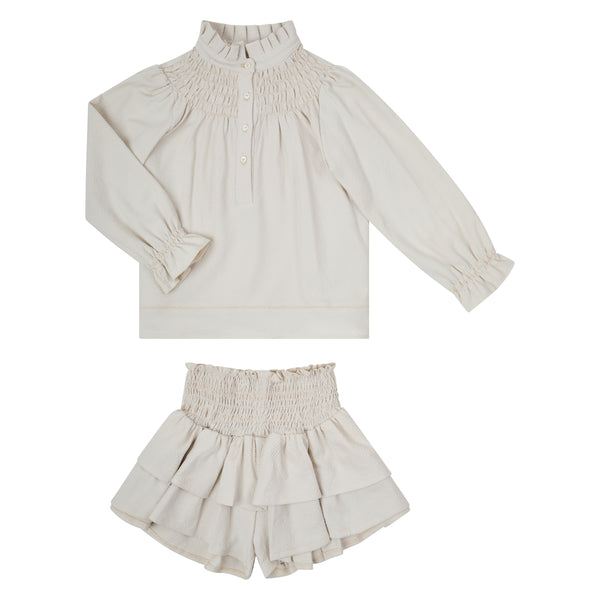 Conj. Blusa Niña Con Smock Y Aletilla Con Falda Short Ornamental Picueta Arena
